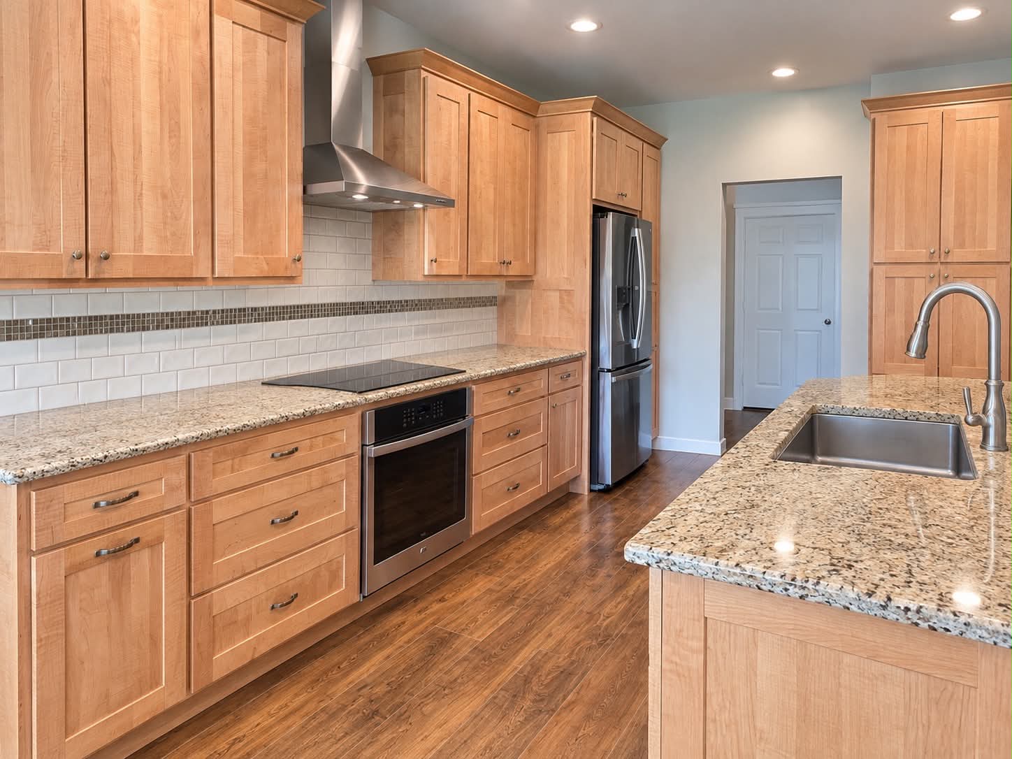 Kitchen with wood cabinets, granite countertops, and stainless steel appliances
